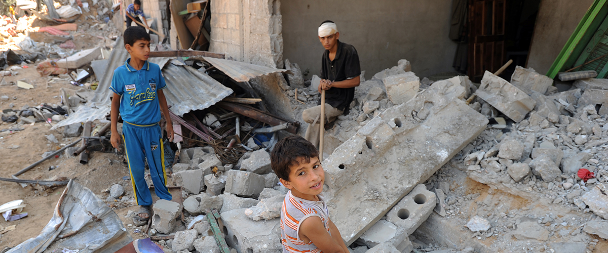 A Palestinians searches through rubble of his destroyed homes hit by Israeli strikes in Khuzaa, east of Khan Younis